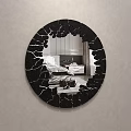 Round Mirror With Black Cracked Frame Reflects Bedroom Bed And Pillows