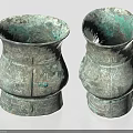 Pair Of Ancient Style Ceramic Vessels With Intricate Carvings And Green Patina