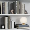 Stylish Decorative Ornament Collection With Books Photo Frames Round Decor And Lamp On Shelf