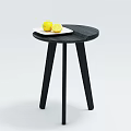 Black Round Three Legged Coffee Table With White Plate Holding Lemons Including Sliced Half 3d model