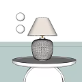 Stylish Table Lamp With White Textured Base And Beige Fabric Lampshade On White Round Tray