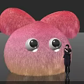 Pink Fluffy Inflatable Model With Large Ears Big Eyes And Person Standing Beside