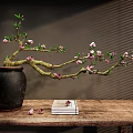 Ceramic Jar With Pink Flowers Branch On Wooden Table Beside Books And Scattered Petals