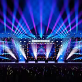 Colorful Concert Stage with Large LED Screen and Audience Waving Light Sticks