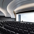 Modern Conference Room Interior With Curved Ceiling LED Lighting Rows of Seats and Lecture Stage