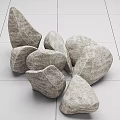 Natural Gray Irregular Stones Decorative Pile Against White Tile Wall and Floor Background