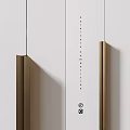 Modern Storage Cabinet With White Panels Gold Handles And Adjacent Bookshelf With Books Decorative Items