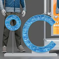 Shopping Mall Clothing Store Featuring Mannequin Wearing Blue Jacket And Display Stand With Letter Decor