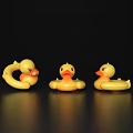 Three Yellow Rubber Ducks in Different Poses on Black Background 3d model