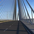 Modern Cable Stayed Bridge Spanning Calm Water Under Clear Blue Sky With Tall Piers