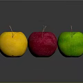 Four Colorful Apples in Yellow Red Pink and Green on Dark Background