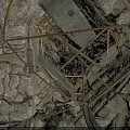 Deep Pit Structure With Rough Stone Walls Wooden Frames And Hanging Ropes