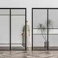 Modern sliding doors with patterned glass and mesh curtains in interior with potted plants