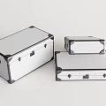 Silver Metal Storage Trunks With Black Corner Accents And Latches In Various Sizes