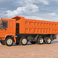 Orange Large Dump Truck Driving On Sandy Ground Under Blue Sky White Clouds