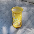 Outdoor Yellow Cylindrical Commercial Equipment Featuring CONGOS Branding Against Brick Wall with Palm Tree Shadows