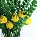 Beautiful Yellow Tulips With Green Leaves In Transparent Glass Vase