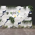 Decorative Background Wall With White Square Panels Green Plants Blue Bows And White Flowers