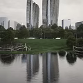 Modern Tall Office Buildings With Glass Exterior Surrounded By Green Grass Trees And Lake