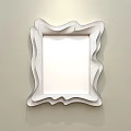 Mirror With Irregular Wooden Frame Reflecting Bedroom Scene With Bed And Pillows