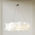 Modern White Chandelier With Wavy Design Hanging From Metal Wires In Minimalist Interior