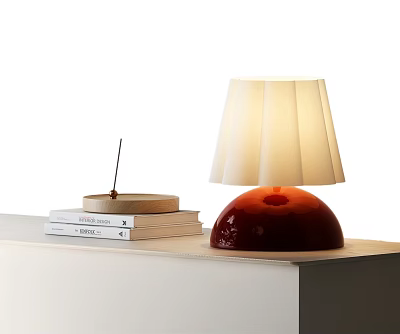 Red Base Table Lamp With Pleated White Lampshade And Books On Table 3d model