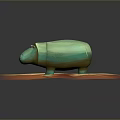 Small Green Hippo Shaped Figurine Placed On Orange Striped Round Base