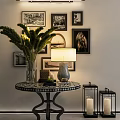 Interior Decor Setup With Round Table Vase Green Plants Lamp Lantern Candlesticks And Wall Framed Art