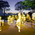 Outdoor Lights Illuminating Natural Garden With Grass Stones Stream Trees And Moonlit Night
