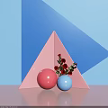 Decorative Geometric Display With Pink Triangle Red Blue Spheres And Red Flowers