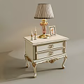 Classic White Bedside Table with Gold Accents Table Lamp Photo Frame and Candle Holders