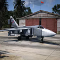 Gray Military Fighter Jet Number 30 Parked On Tarmac Near Hangar