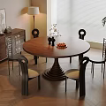 Stylish Dining Room With Round Wooden Table Black Chairs Cabinet And Plant