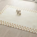 Stylish Square Carpet With Beige And Gold Checkerboard Border On Light Wooden Floor