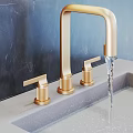 Contemporary Stylish Faucet Designs in Brushed Gold and Chrome with Smooth Water Flow on Countertop Surfaces