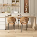 Modern Open Kitchen Dining Area Interior With White Cabinets Island And Rattan Chairs