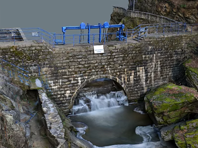 Stone Arch Structure With Flowing Water And Blue Railings In Rocky Surroundings 3d model