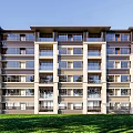 Modern Multi Story Apartment Building Exterior With Green Lawn And Clear Blue Sky