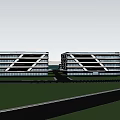 Modern Industrial Factory With Multistorey Structure And Large Glass Windows Surrounded By Trees And People