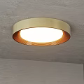 Round Ceiling Light With Golden Lampshade White Light And Orange Stripes Mounted On Gray Ceiling