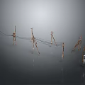 Multiple Metal Utility Poles Arranged in a Row With Gray Background and Reflections