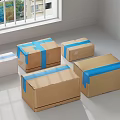 Brown and white cardboard boxes with blue tape in sunlit room