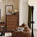 Comfortable Brown Bean Bag Chair With Plaid Cushion Wooden Chest Vase Flowers And Framed Artwork