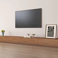 Wooden TV Stand with Vase of Yellow Flowers Books and Framed Art under Mounted TV