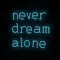Stylish Blue Neon Decorative Light Displaying Never Dream Alone Against Black Background