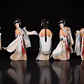 Women in Traditional Costumes with Various Poses Against Black Background and Reflective Floor