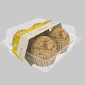 Transparent Plastic Packaged Cupcakes With Yellow Labels And Patterned Tops Stacked Together