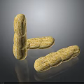 Three Roasted Peanuts With Crunchy Texture And Golden Color On Dark Surface