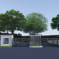Modern Entrance Gate With Green Trees Metal Fence And Black Pavement