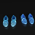 Four pairs of blue semi transparent shoes on black background